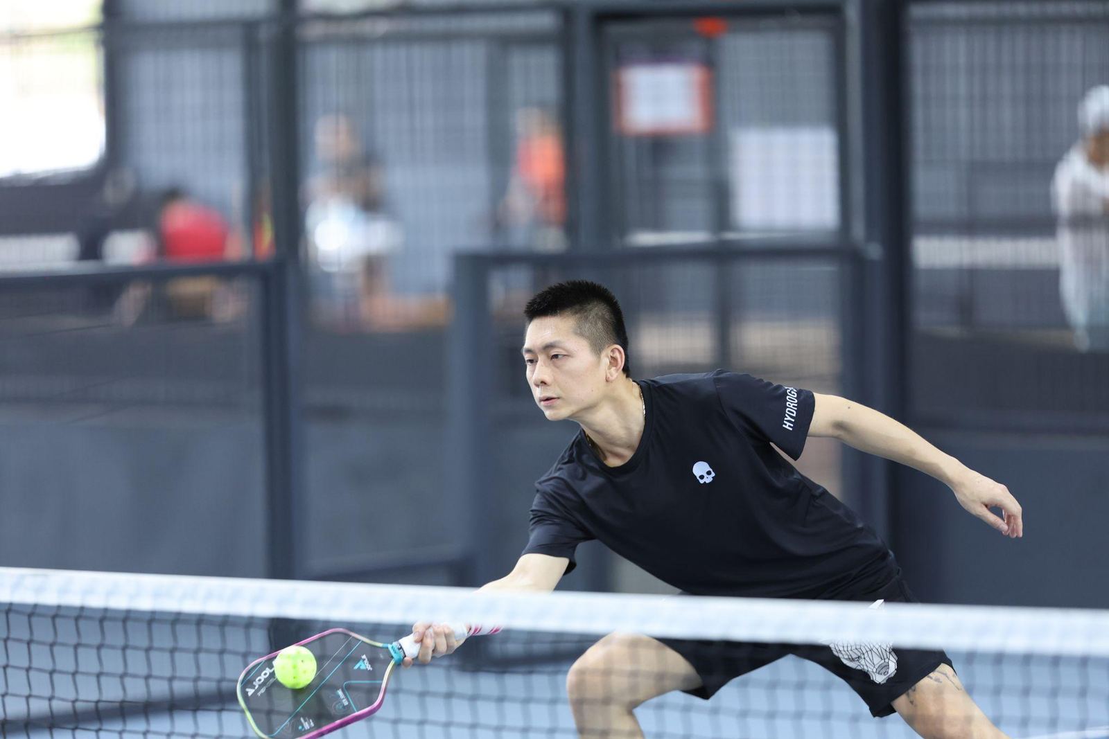 Pickleball player volleying at the net