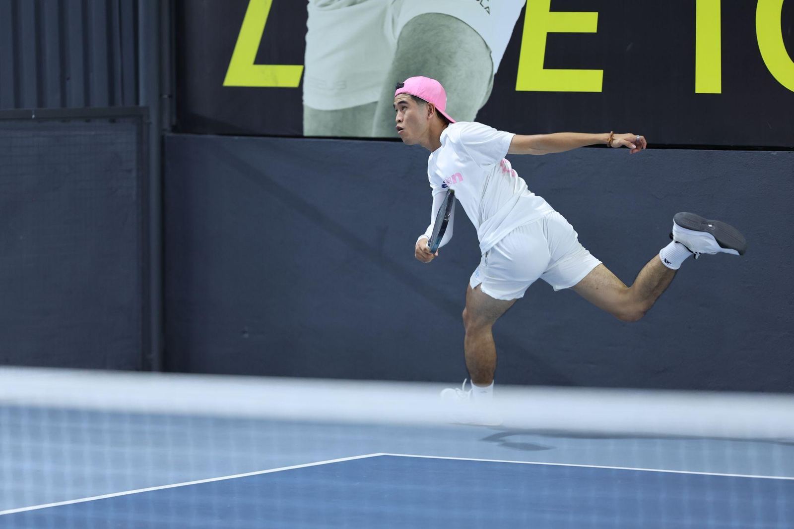 Pickleball player serving